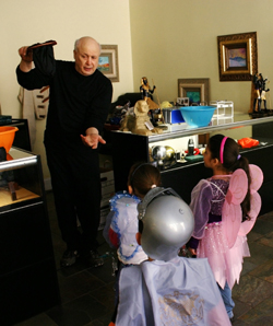 photo of E.J. Gold appearing candy out of thin air for young spectators
