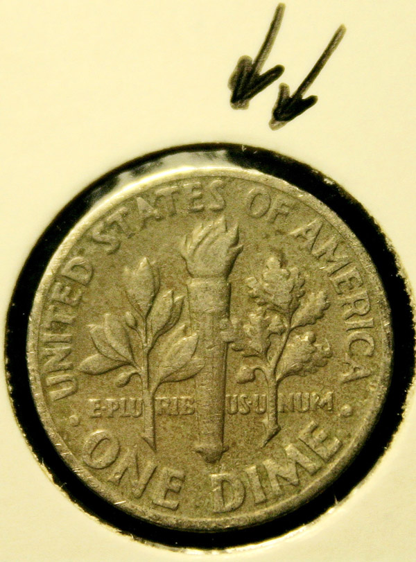 Closeup of 1970 dime showing an anomaly in the flame area