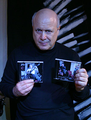 E.J. Gold holding the Demo and Blues Basics CDs